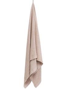 Rento Kenno beige bath towel 90 x 180 cm hanging on a hook.